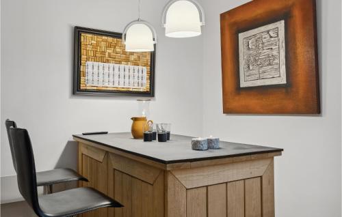 a desk in a room with a chair and a picture at 3 Bedroom Gorgeous Home In Lem St in Karsbæk