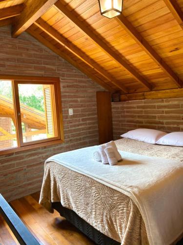Postel nebo postele na pokoji v ubytování Villetta Gramado Roma