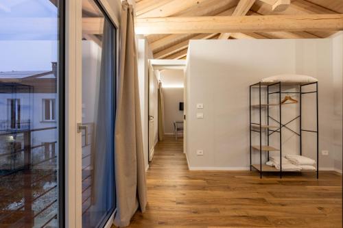 a room with a wooden ceiling and a glass shelf at Guest house Neive in Neive