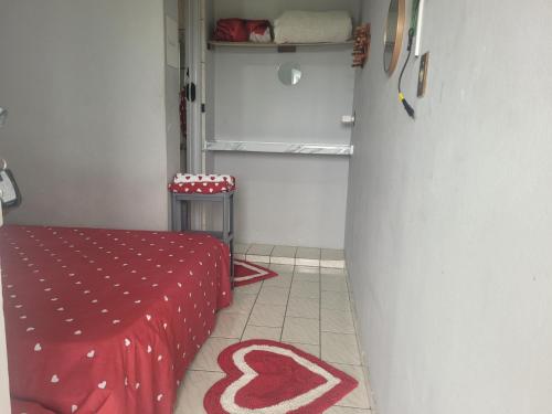 a room with a table with a red table cloth at Unidades 1 e 2 e 3 Pousada do Sossego Mar e Verde in Itanhaém