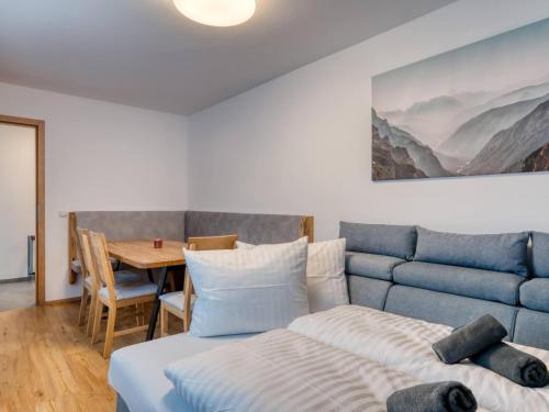 a bedroom with a bed and a dining table at Chalet Bergglück in Sellrain
