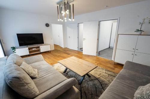 a living room with a couch and a table at Quiet House - 10 min away from Cologne in Bergisch Gladbach