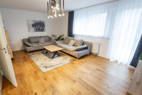 a living room with a couch and a table at Quiet House - 10 min away from Cologne in Bergisch Gladbach