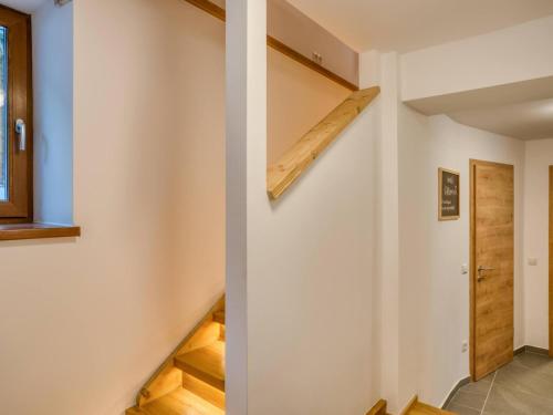 a staircase in a house with wooden shelves at Chalet Bergglück in Sellrain