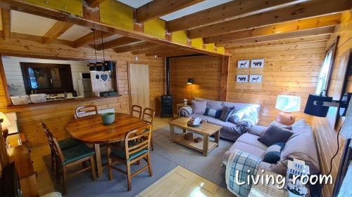 a living room with a couch and a table at CASA ABETOS Elite in Sierra Nevada