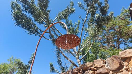 a metal object in front of a tree at B&B Buenavista Barichara in Barichara