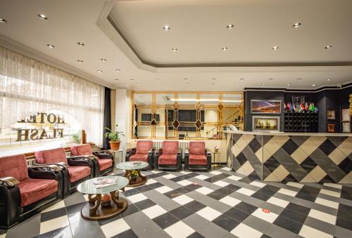 a lobby of a hotel with chairs and a bar at Hotel Flash in Istanbul