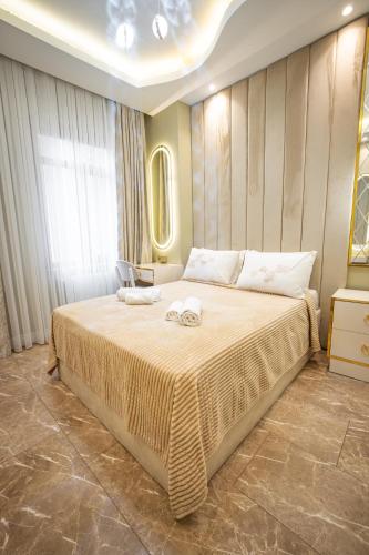 a bedroom with a large bed with two towels on it at Hotel Flash in Istanbul