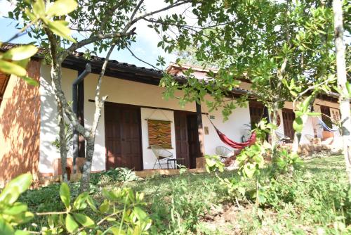 a house with a hammock in front of it at B&B Buenavista Barichara in Barichara