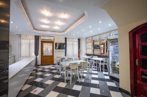 a dining room with a table and chairs on a checkered floor at Hotel Flash in Istanbul