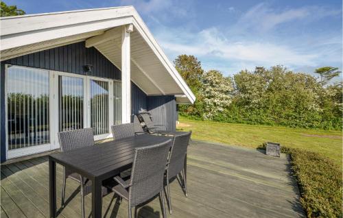 a patio with a table and chairs on a house at Holiday Home Gunhildsvej Vestervig in Vestervig