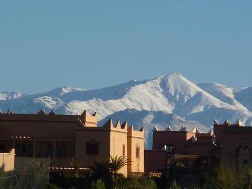 a mountain with snow covered mountains in the background at Les Tourmalines in Ouarzazate