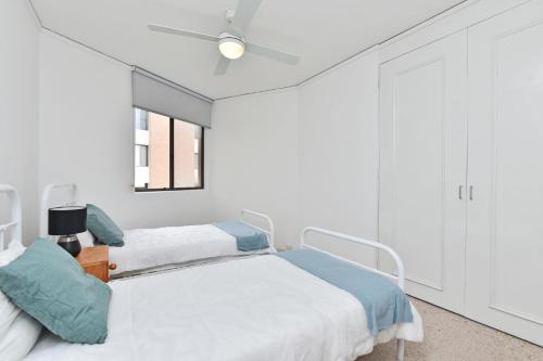 a hospital room with two beds and a window at Triview Mitchell Street Unit 4 1 Soldiers Point in Soldiers Point