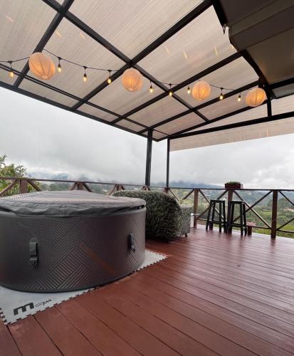 a deck with a hot tub on a roof at Eco Lodge Glamping in Guatapé