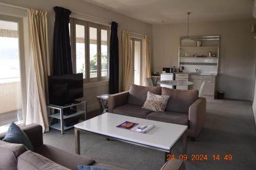 a living room with a couch and a coffee table at Akaroa Village Inn in Akaroa