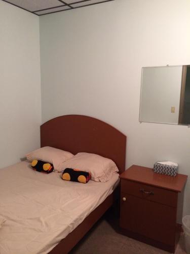 a bedroom with a bed with two pillows on it at Manhattan Bowery Lodge in New York