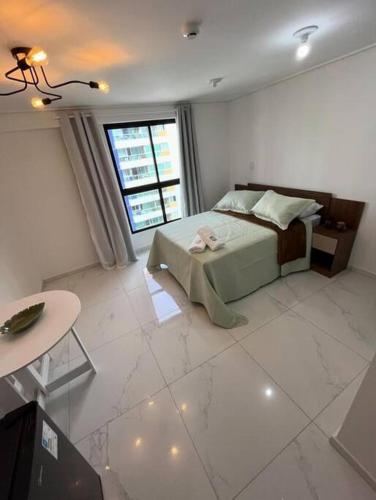 a bedroom with a bed and a table in it at Move 517 in João Pessoa