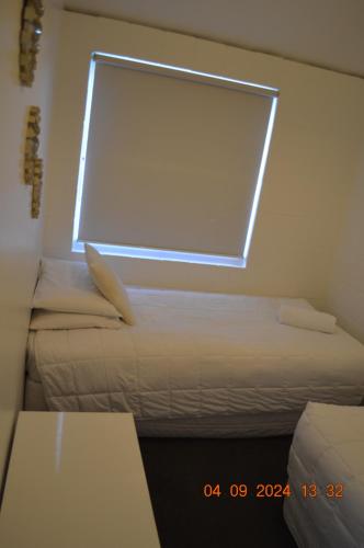 a room with a large window and a bed at Akaroa Village Inn in Akaroa