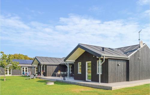 a house with a black roof at Holiday Home Sæby 59 in Nordost