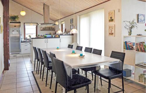 a kitchen and dining room with a table and chairs at Holiday Home Hulvej Vinderup Vi in Vinderup