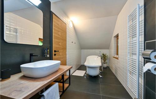 a bathroom with a white tub and a sink at Cozy Home In Vitesinec With Sauna in Salinovec