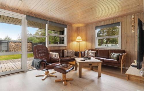 a living room with a couch and chairs and windows at Holiday Home Musvågevej I in Ålbæk