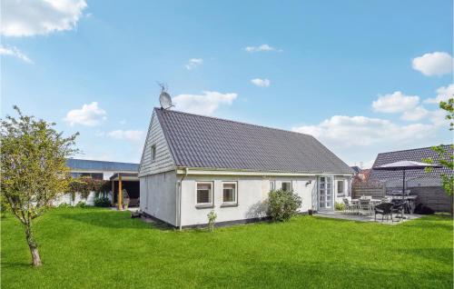 a small white house with a grass yard at 3 Bedroom Gorgeous Home In Asaa in Aså