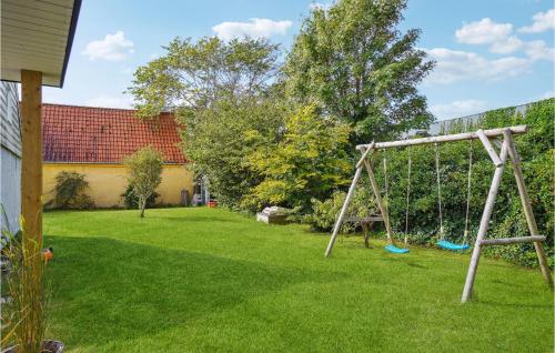 a swing set in the yard of a house at 3 Bedroom Gorgeous Home In Asaa in Aså