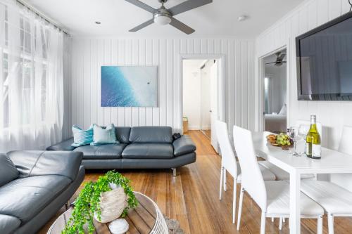 a living room with a couch and a table at Orton Blue- Beachside getaway for 4, Pets welcome, Aircon, Park and walk to everything! in Ocean Grove