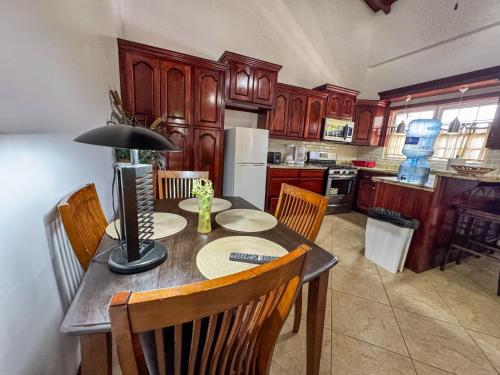 a kitchen with a table with a lamp on it at Caribbean Shores Belize in Hopkins