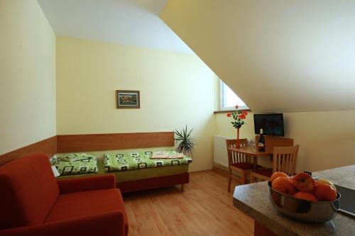 a living room with a couch and a table at Wellness Penzion Pod Rozhlednou in Kostelec nad Orlicí