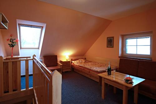 a small room with a bed and a table at Wellness Penzion Pod Rozhlednou in Kostelec nad Orlicí