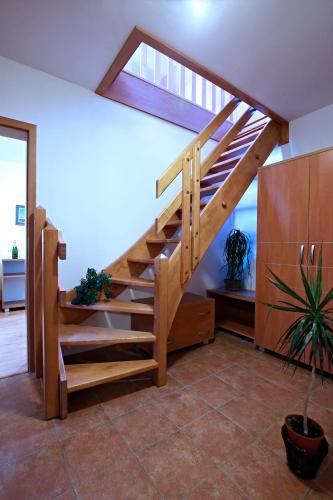 a wooden staircase in a living room at Wellness Penzion Pod Rozhlednou in Kostelec nad Orlicí