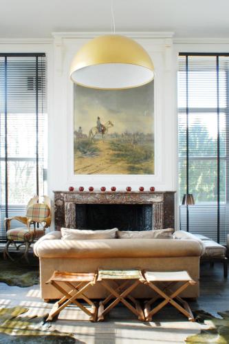 a living room with a couch and a fireplace at Domaine de Ronchinne - Château et Ecuries in Maillen