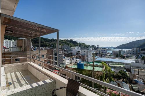 a balcony with a view of a city at Geoje Hound Hotel & Spa in Geoje 