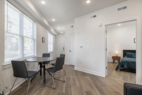 a room with a table and chairs and a bed at Tourist Home of Richmond - Church Hill North Apt01 in Richmond