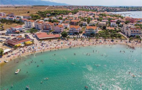 an aerial view of a beach with people in the water at Nice Apartment In Povljana With Kitchen in Povljana