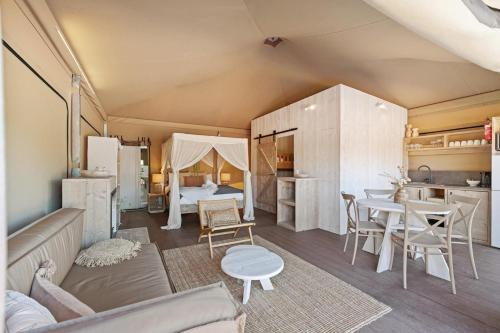 a living room with a couch and a room with a bed at BIG4 Ingenia Holidays Inverloch in Inverloch