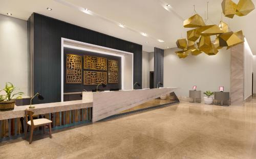 a lobby with a reception desk and a chair at Summit Galleria Cebu in Cebu City