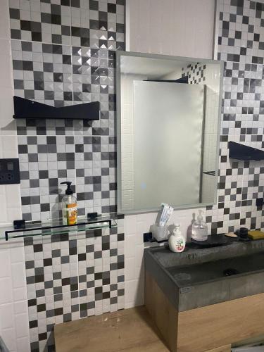 a bathroom with a sink and a mirror at Momento Resort in Pattaya South