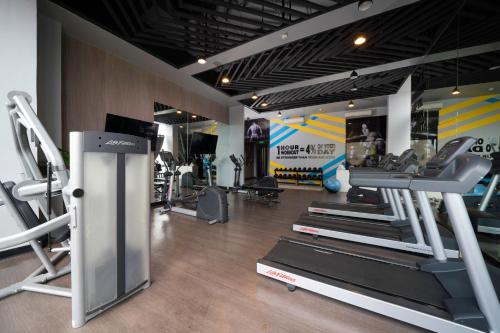 a gym with several tread machines in a room at Summit Galleria Cebu in Cebu City
