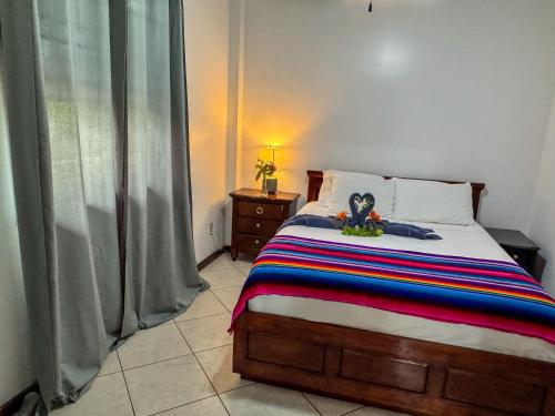 a bedroom with a bed with a stuffed animal on it at Caribbean Shores Belize in Hopkins