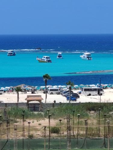a view of a beach with boats in the water at See you soon Matrouh 1 in Marsa Matruh