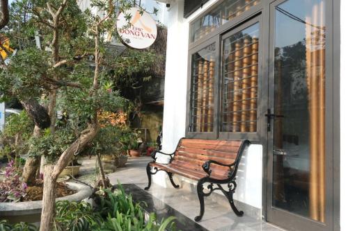 a wooden bench sitting outside of a store at Epic Đồng Văn Hotel in Dồng Văn