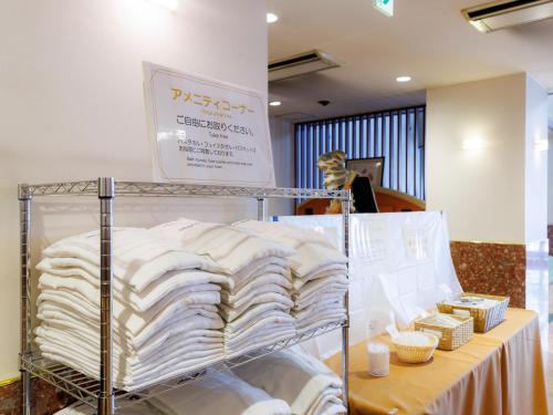 a display of towels on a table in a store at Tabist ASAHIKAWA STATION HOTEL in Asahikawa