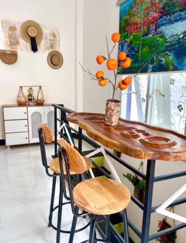 a dining room with a wooden table and chairs at Hoàng Nga 2 Homestay in Phan Thiet