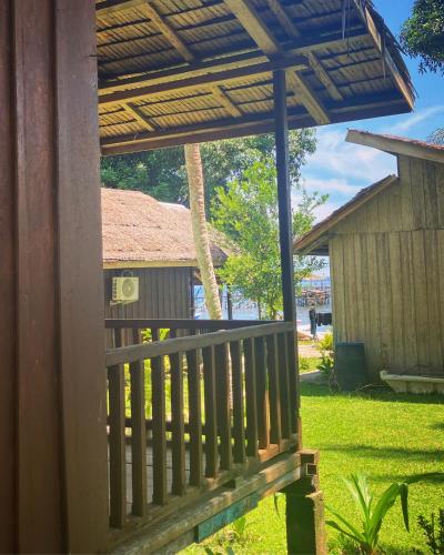 a porch of a house with a roof at Pristine Paradise Dive Resort - Togean Islands, Una Una in Pulau Unauna