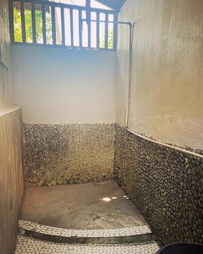 a bathroom with a walk in shower with a staircase at Pristine Paradise Dive Resort - Togean Islands, Una Una in Pulau Unauna