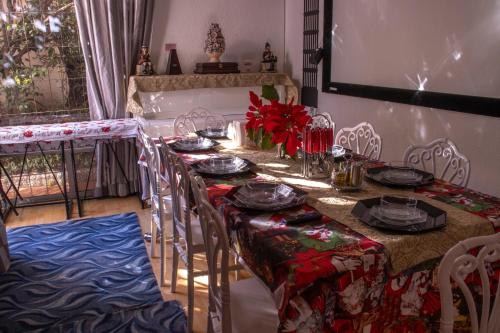 a dining room table with chairs and a table with plates at Casa en centro de Coyoacán in Mexico City