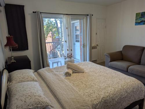 モントリオールにあるComfy apartment close to Metro Monk station with self check inのベッドとガラスの引き戸のある寝室